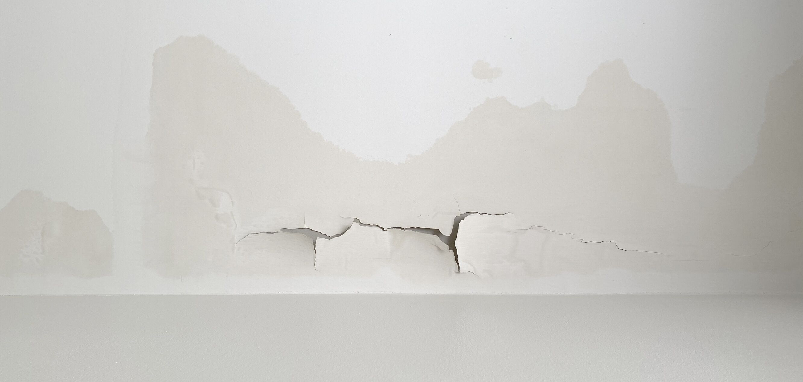 Farbablösungen an einer Wand aufgrund von Nässeschaden